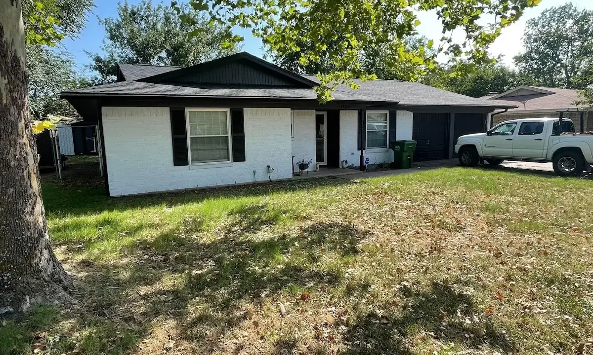 Professional roofing crew working on a residential roof in Rye
